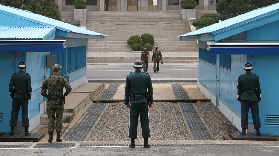 UNC soldiers standing guard in the Joint Security Area (JSA) between the blue buildings. View from the south. To the rear is the Panmungak building, located in the DPRK.